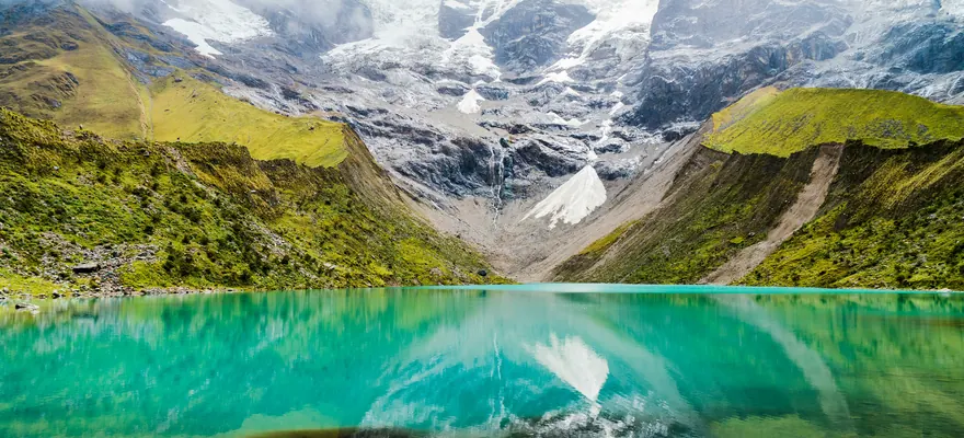 Turquoise water of Humantay Lake below the glacier