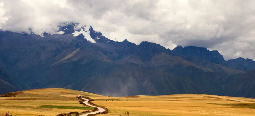 Snow-capped peak and a road through the fields of the Sacred Valley